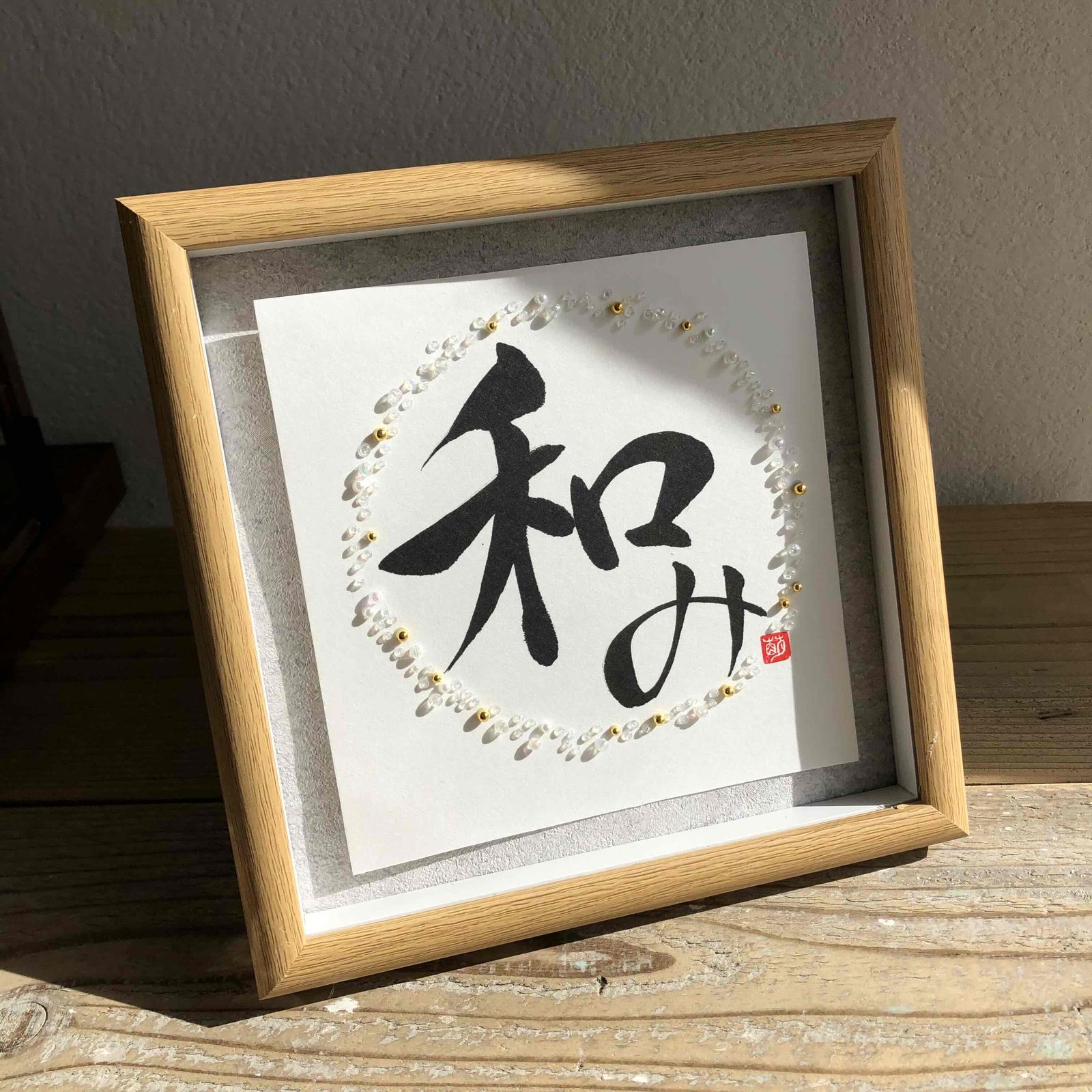 A framed Gemgraphy calligraphy work with natural stone and light